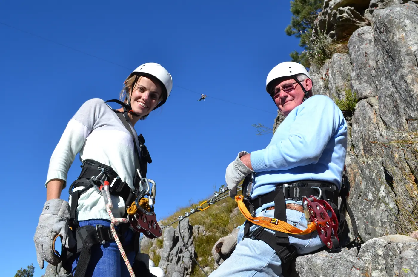 A grandfather and granddaughter kitted up on a Cape Canopy Tour zipline platform